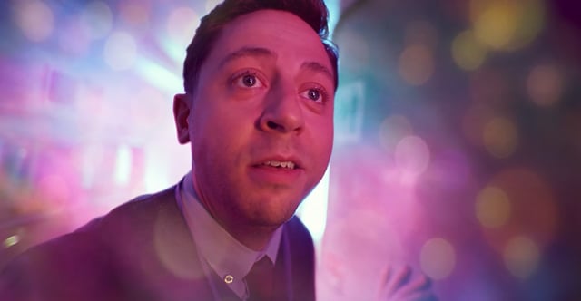 A man in a pod lit pink and purple, from Love Is Blind