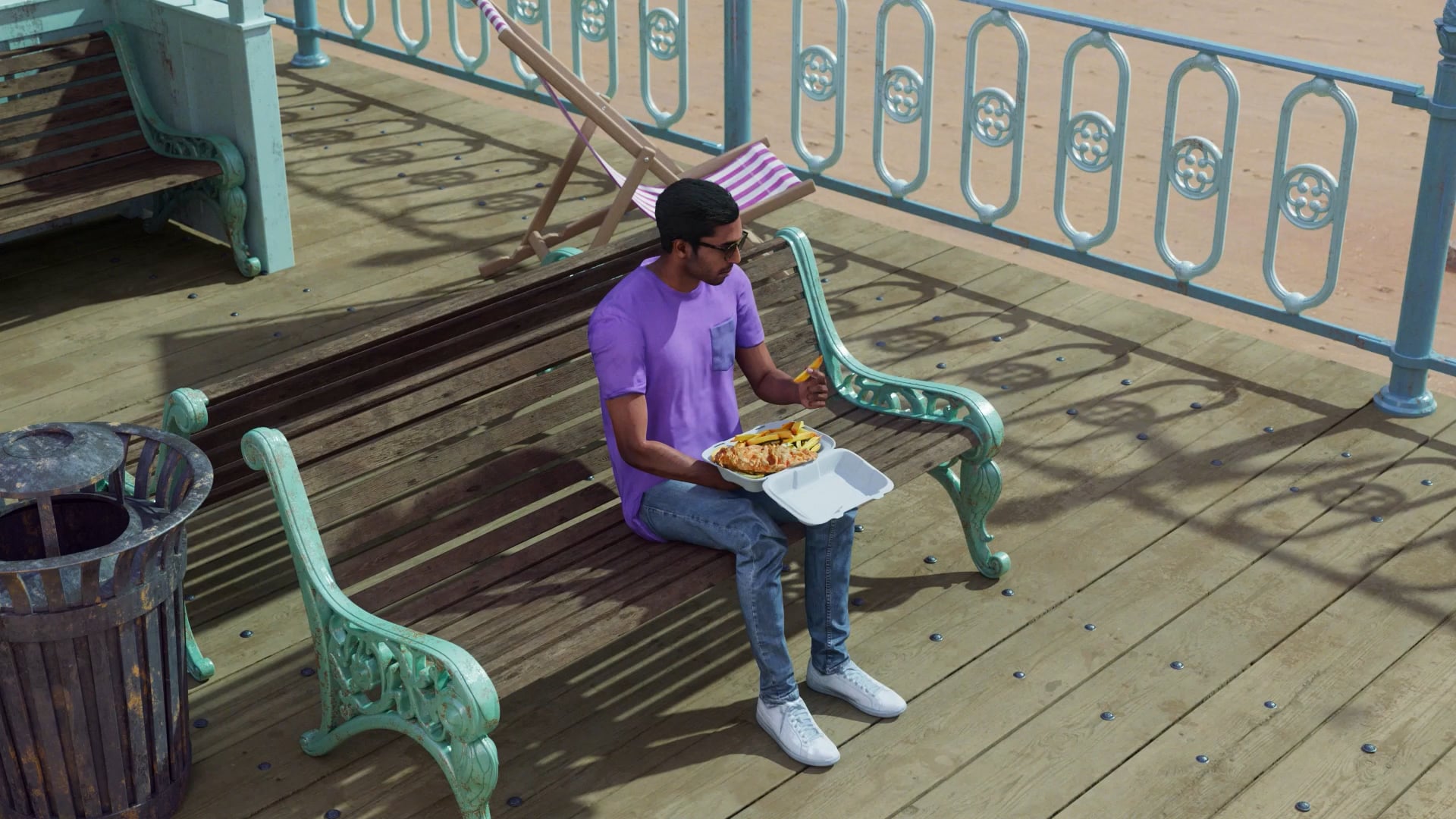 A man eating chips on a seaside bench