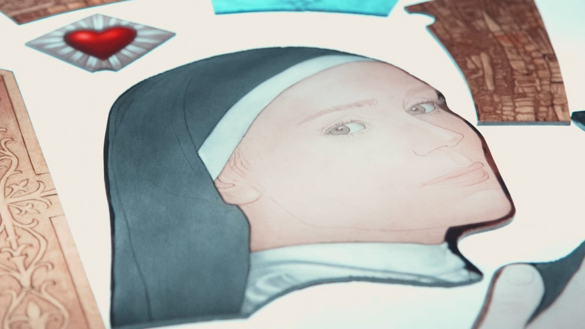 A hand-painted stained-glass panel of the nun's face, mid-assembly